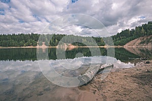 calm lake with reflections of clouds in summer- vintage retro l