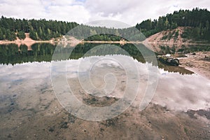 calm lake with reflections of clouds in summer- vintage retro l