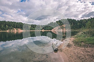 calm lake with reflections of clouds in summer- vintage retro l