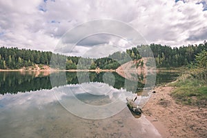 calm lake with reflections of clouds in summer- vintage retro l