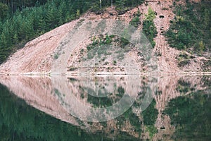 calm lake with reflections of clouds in summer- vintage retro l