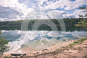 calm lake with reflections of clouds in summer- vintage retro l