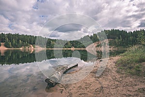 calm lake with reflections of clouds in summer- vintage retro l