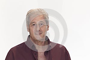 calm looking mature man in purple shirt on white background