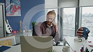 Calm manager mobile calling home closeup. Handsome business man watching laptop
