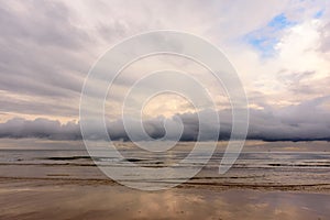 Calm and moody seascape with a dramatic sky before storm.