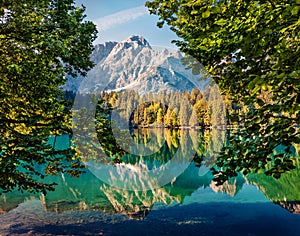 Calm morning view of Fusine lake. Colorful summer scene of Julian Alps with Mangart peak on background, Province of Udine, Italy,