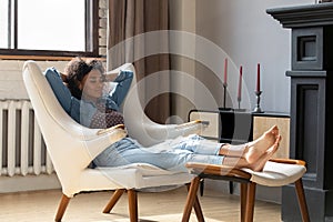 Calm peaceful African woman taking deep breath of fresh air