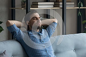 Calm peaceful millennial man taking break and deep breath