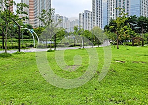 Calm and peaceful park surrounded by high rise apartment building in new town