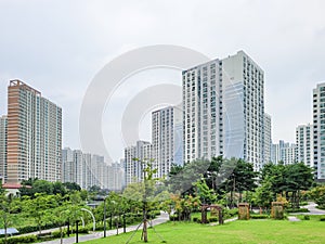 Calm and peaceful park surrounded by high rise apartment building in new town