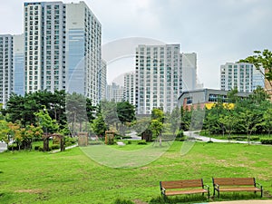 Calm and peaceful park surrounded by high rise apartment building in new town