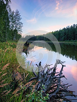 Calm quiet pink sunset on the lake. nature of Russia. Ural. Mirror water.