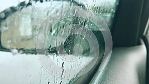 Calm and quiet spring rain. Raindrops running down the windshield of the car.