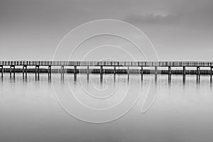 Calm scene in black and white of wooden bridge