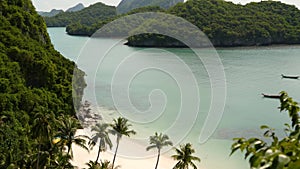 Calm sea near green jungle. Peaceful ocean with turquoise water, white sandy tropical shore in Ang Thong paradise