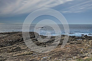 Calm sea scene with rocks in the foreground