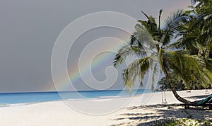 Calm sea before storm with amazing rainbow after the rain -sand beach background