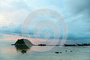 Calm sea at sunset time with islands and boats