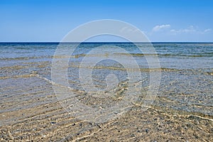 Calm sea surface near coastline.