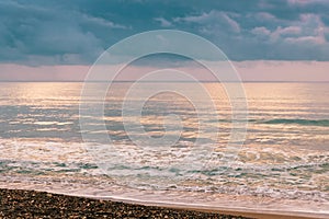 Calm sea waves against a dark and stormy sky