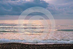 Calm sea waves against a dark and stormy sky