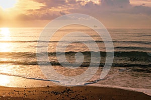 Calm sea waves in golden light in Larnaca