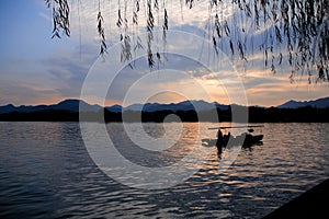 A calm seascape with mountains at sunset. Dramatic sky and cloudscape