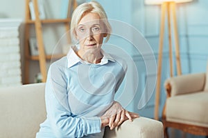 Calm senior woman sitting and waiting for her doctor