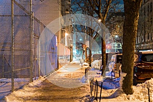 Calm and serene night scene showing an empty and quiet street in New York City`s Harlem neighborhood