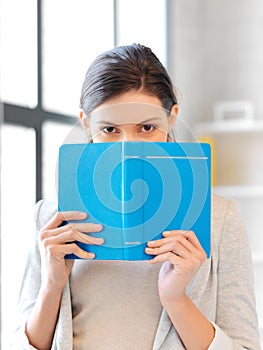 Calm and serious woman with book