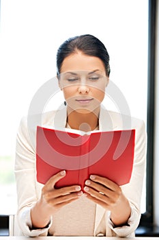 Calm and serious woman with book