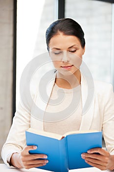 Calm and serious woman with book