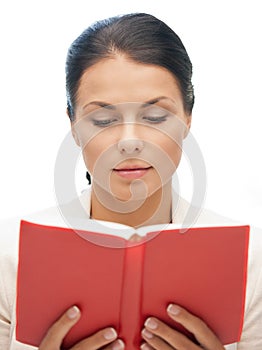 Calm and serious woman with book