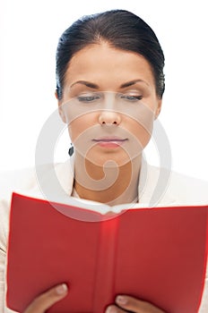 Calm and serious woman with book