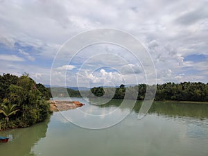 Calm still water river and cloudy sky