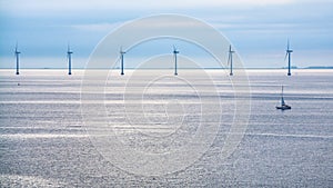 Calm surface of Baltic Sea with offshore wind farm