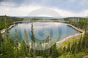 Calm surface Duck Lake in Yellowstone forest