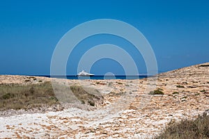 calm torquoise Balearic sea in the sunny day with moored luxurious boat