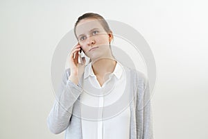 Calm, unemotional woman talks on phone, listens to other person, does not react