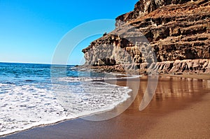 Calm water and blue sky in rustical beach TiritaÃÂ±a. Bay framed photo