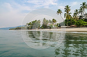 Calm water, palm trees and white sand beach at Tokeh Beach, south of Freetown, Sierra Leone, Africa