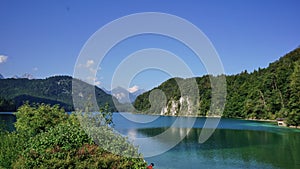 Calm waters of the Alpsee Lake in Bavaria, Germany