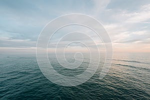 Calm waters of the Pacific Ocean at sunset, from the pier in Newport Beach, California