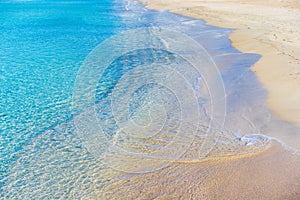 Calm waves with transparent clear sea water on perfect sandy beach