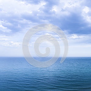 Calm windless ocean in blue tones
