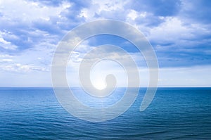 Calm windless ocean with the sun on the horizon