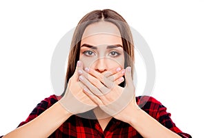 Calm woman making tabu gesture and covering mouth with hands photo