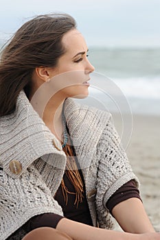 Calm woman portrait alone on a sea beach