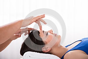 Calm Woman Receiving Reiki Treatment